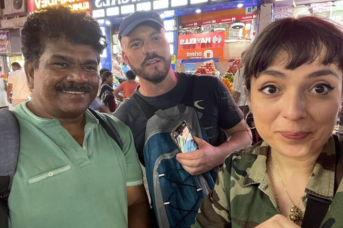 two men and a woman posing for a picture in a store