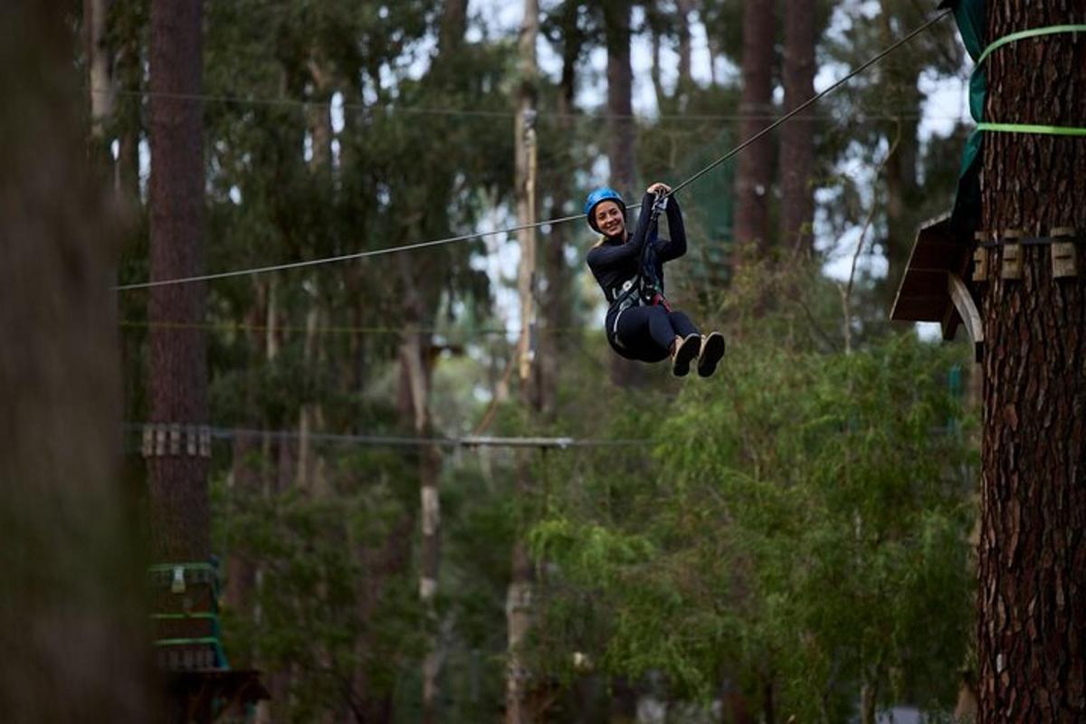 a woman is jumping on a zip line