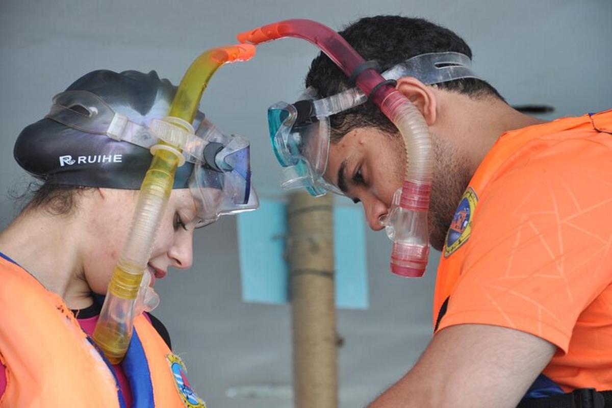two people wearing oxygen cylinders on their heads