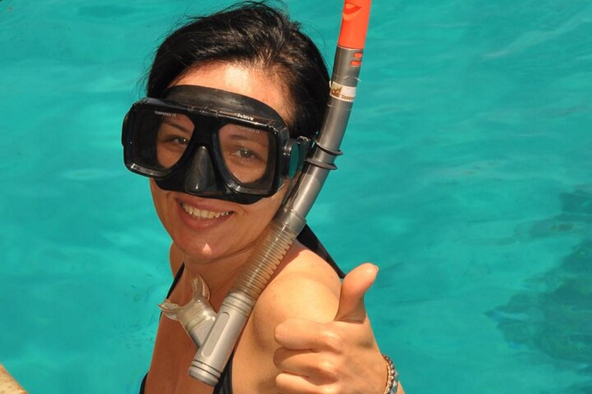 a woman in a pool with a snorkel and a snorkeling