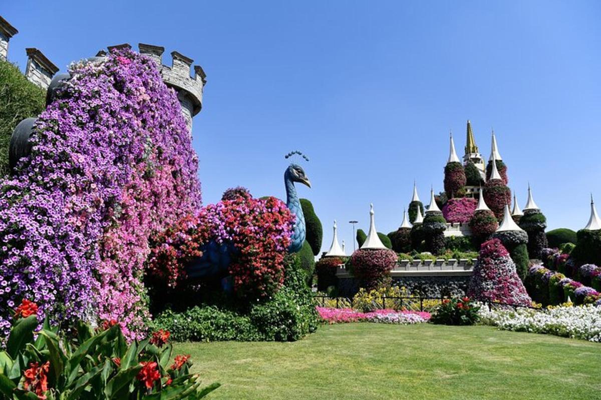 a garden of flowers in front of a castle