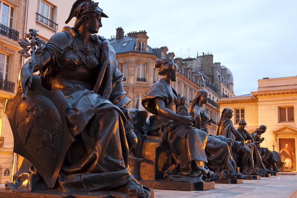a statue of people sitting on horses in front of a building