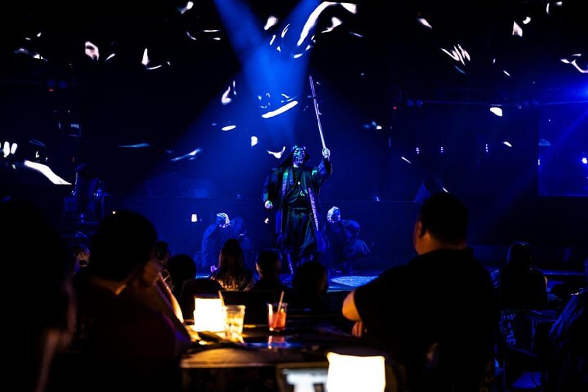 a group of people sitting at a table watching a performance