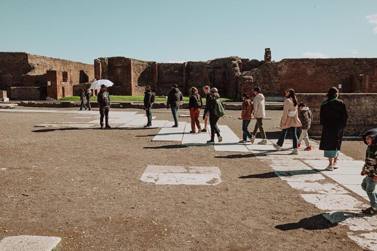 a group of people walking around a ruins