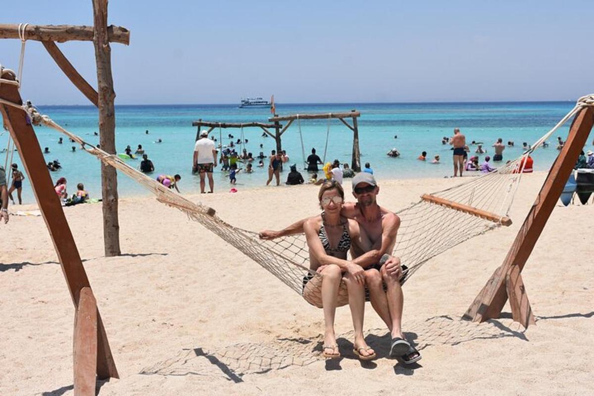 Dos mujeres sentadas en una hamaca en una playa