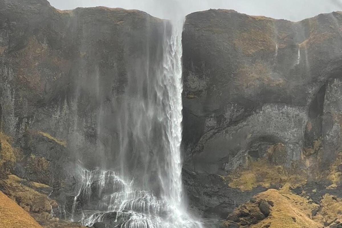 a waterfall on the side of a mountain