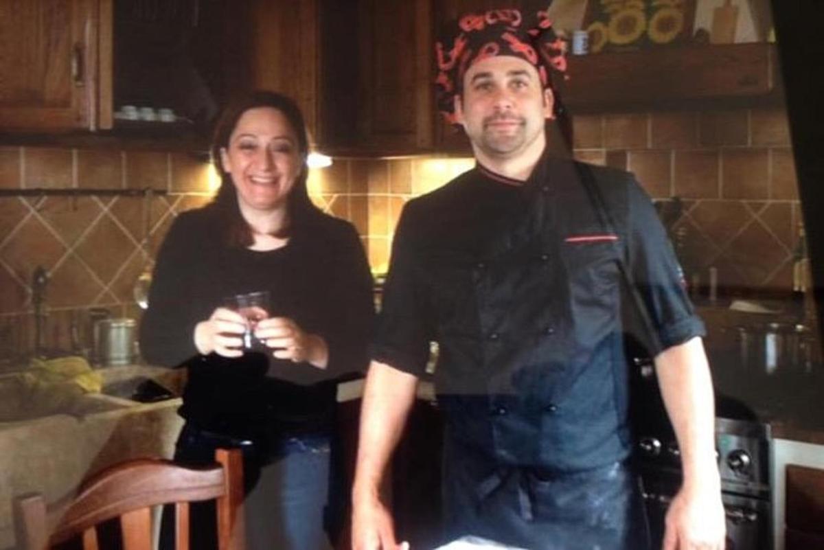 a man and a woman standing in a kitchen