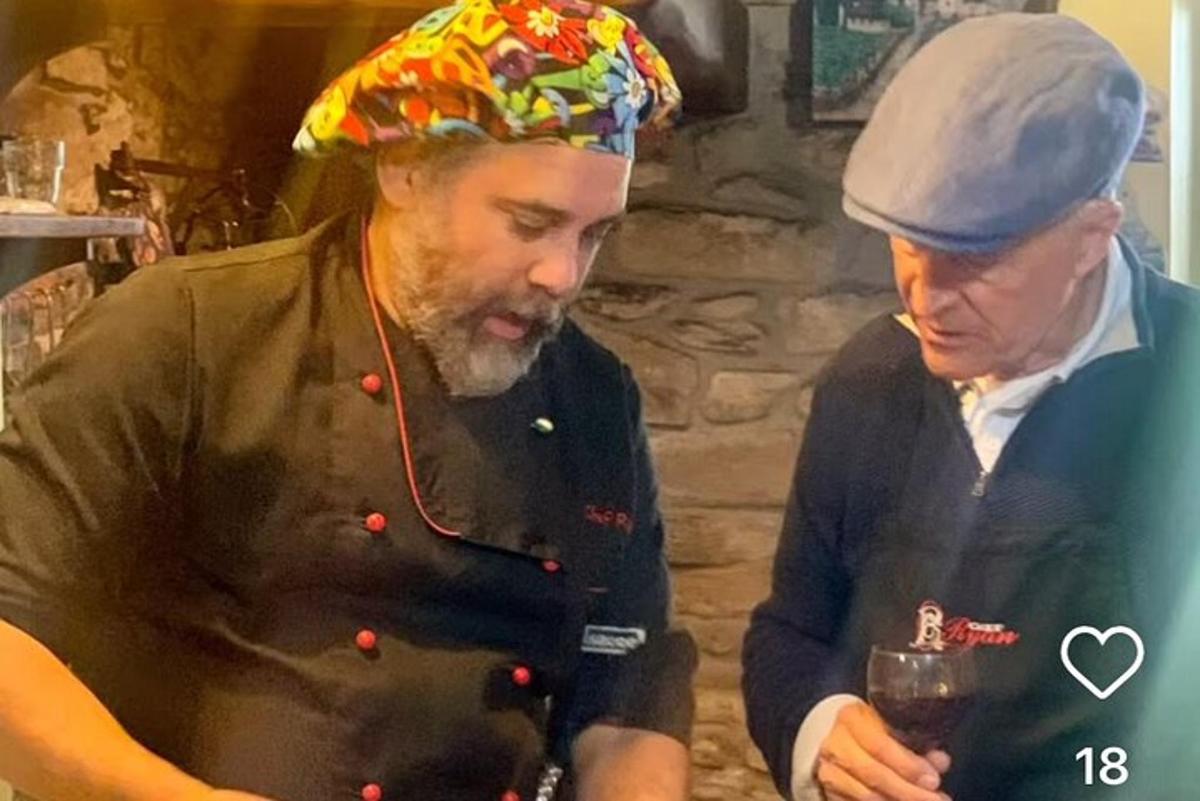 two men wearing hats looking at their cell phones
