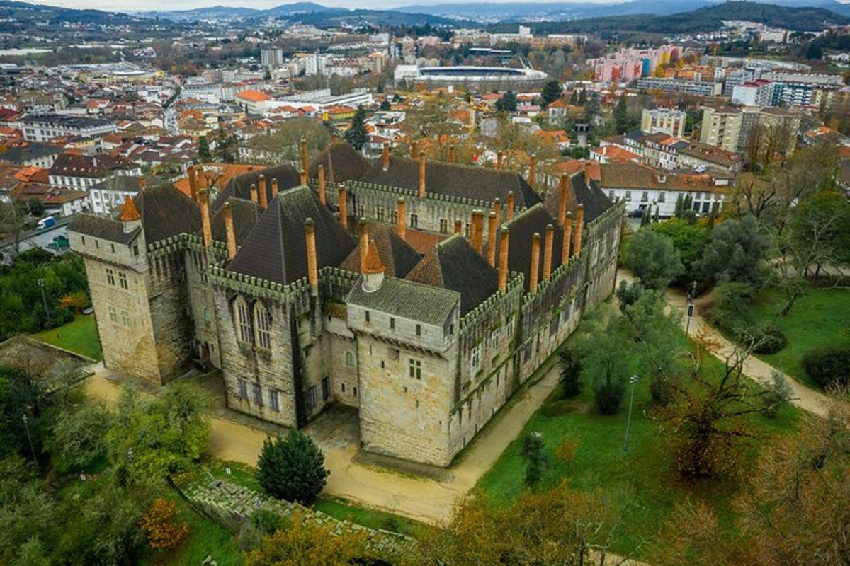 an aerial view of an old castle in a city