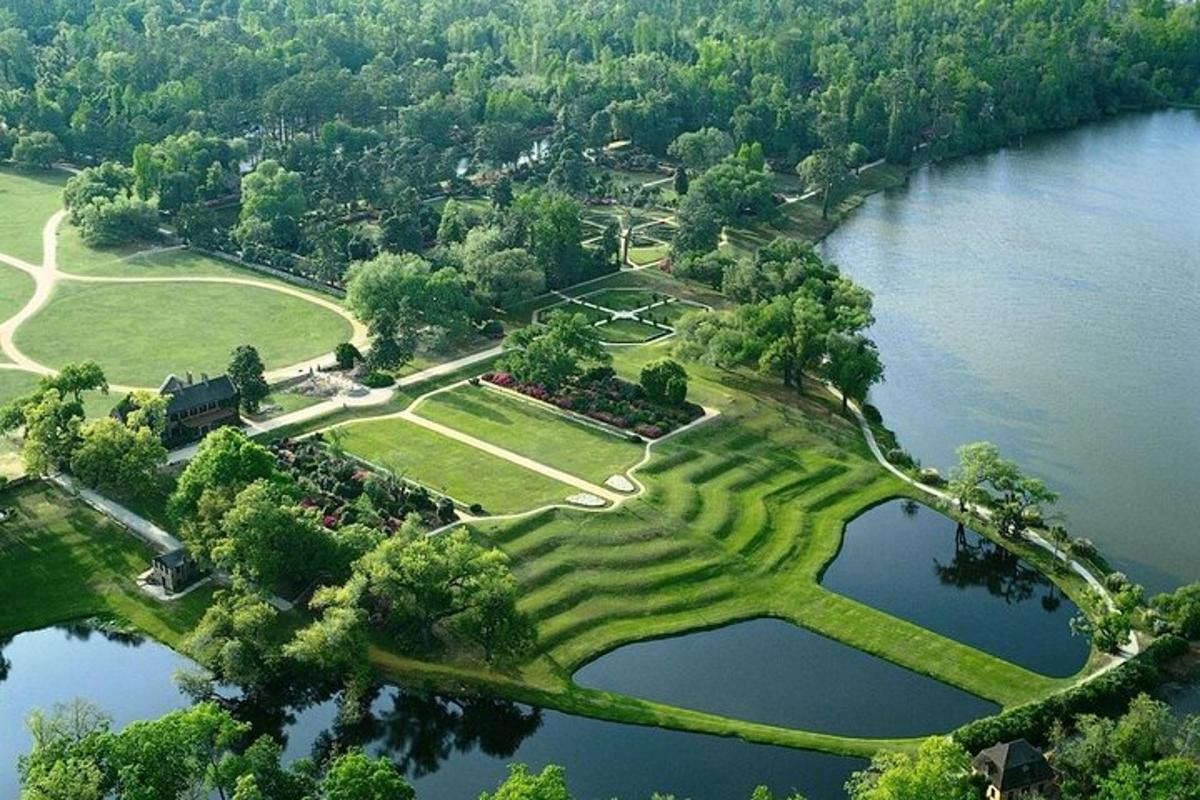 an aerial view of a park next to a lake