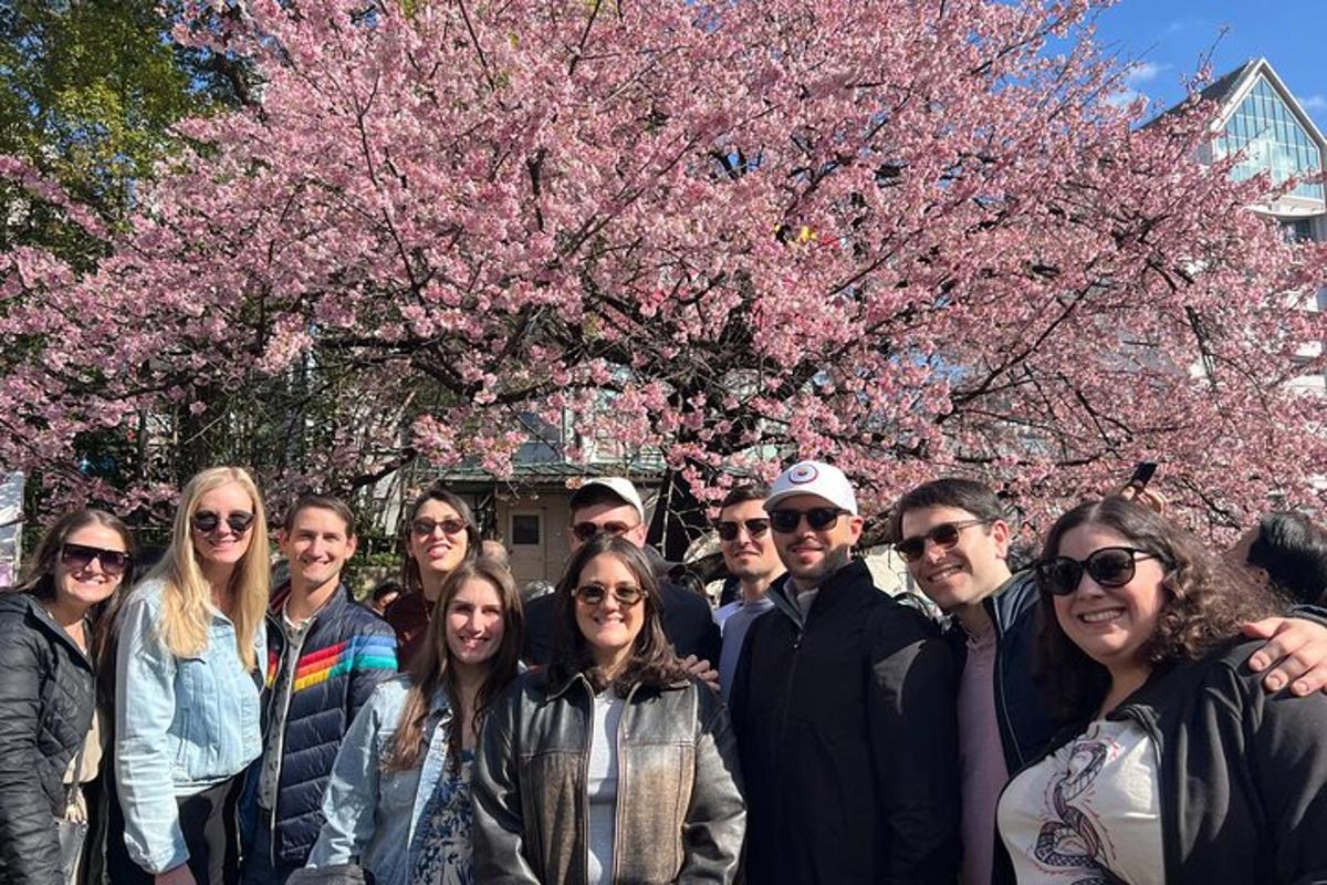 a group of people standing in front of a tree