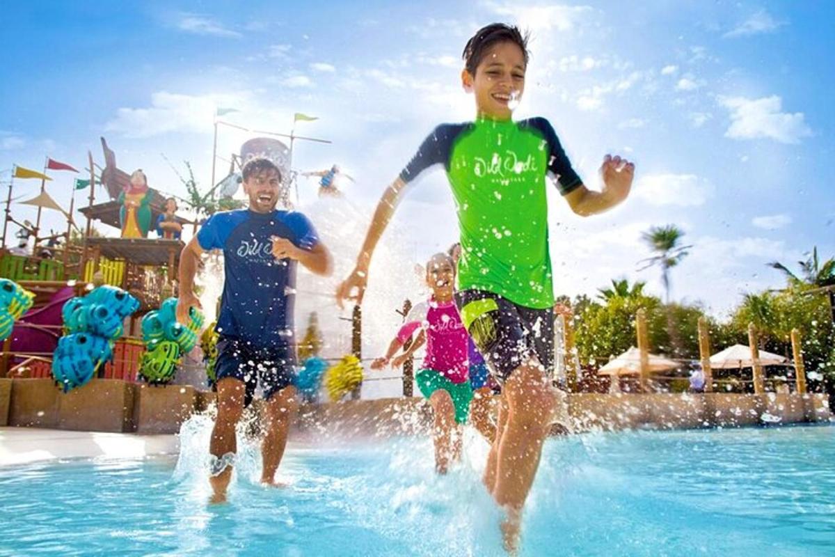 a group of children playing in a water park