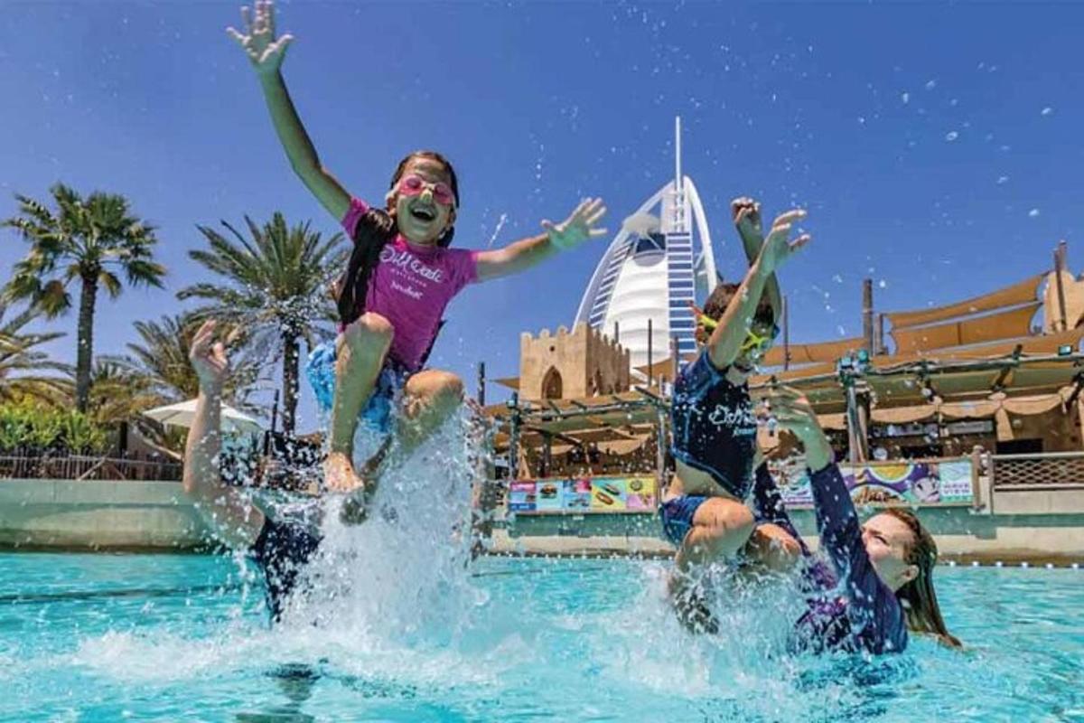a group of people in the water at a pool