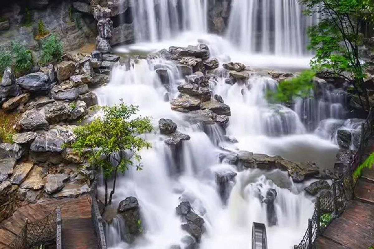 an aerial view of a waterfall in a forest