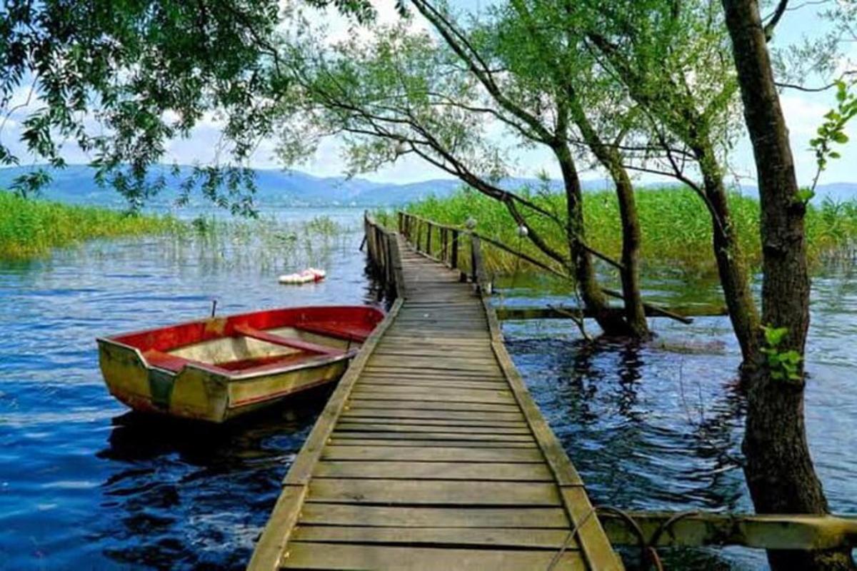a boat sitting on the water next to a dock
