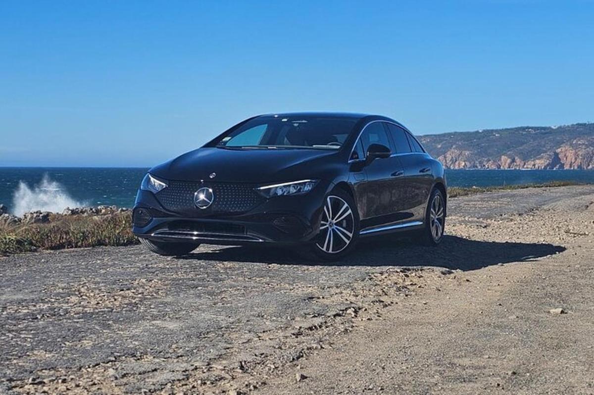 a car parked on a dirt road near the ocean