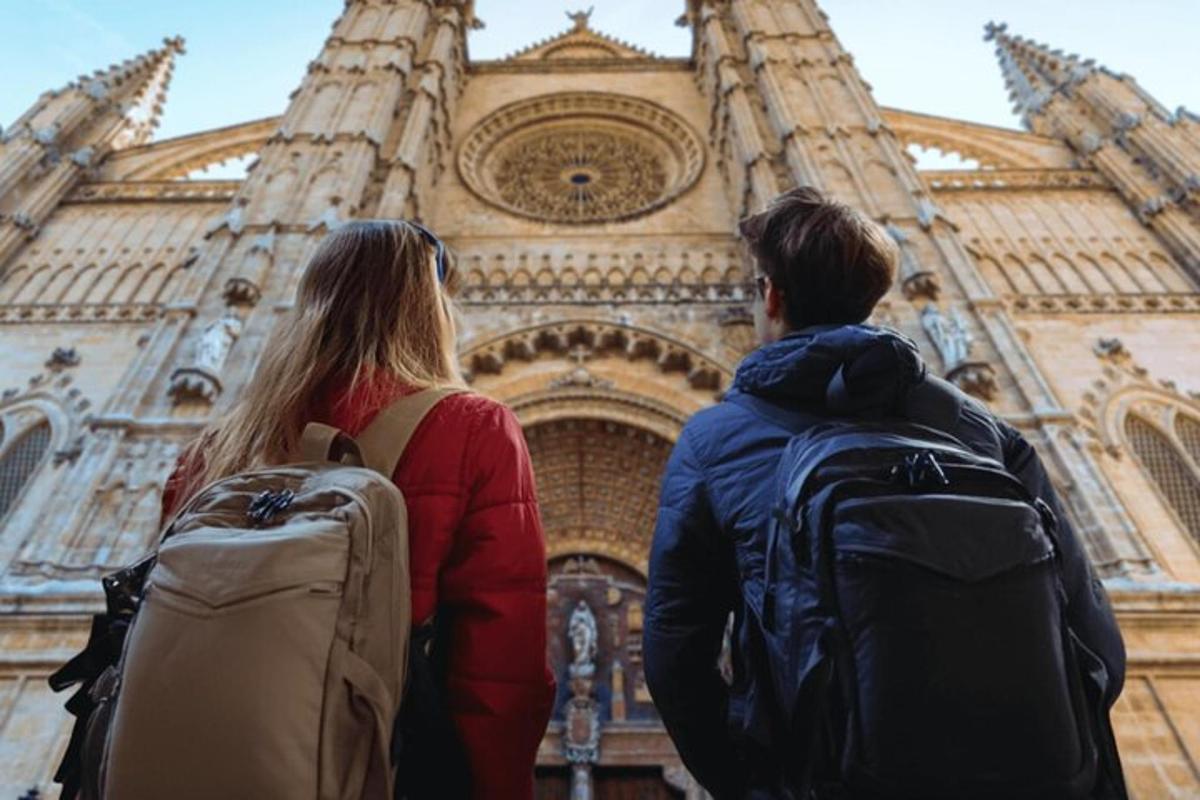two people standing in front of a building
