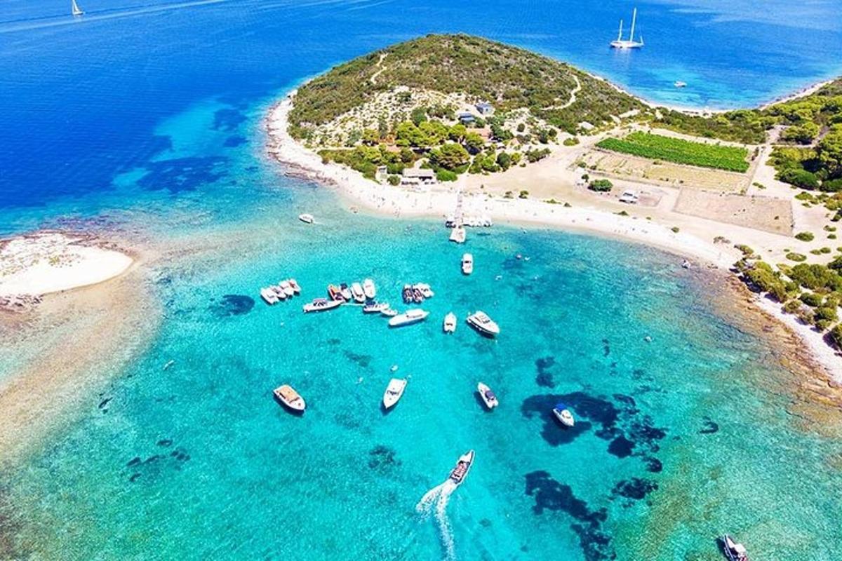 an aerial view of a beach with boats in the water