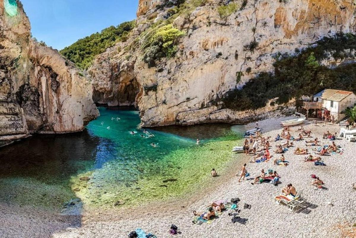 a group of people on a beach in the water