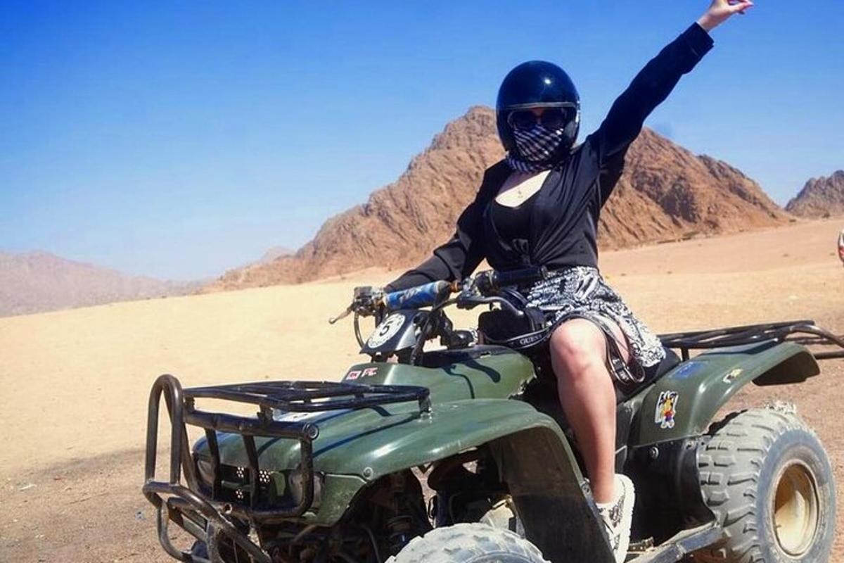 una persona sentada en un vehículo todo terreno en el desierto