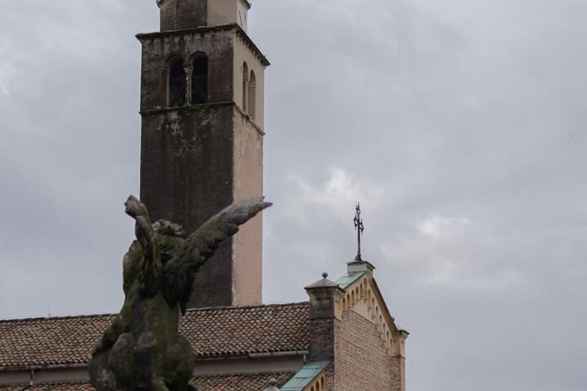 a building with a clock tower and a statue
