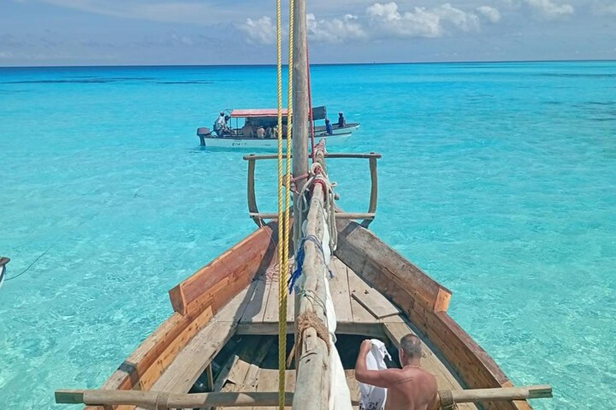 a man standing on the front of a boat in the ocean