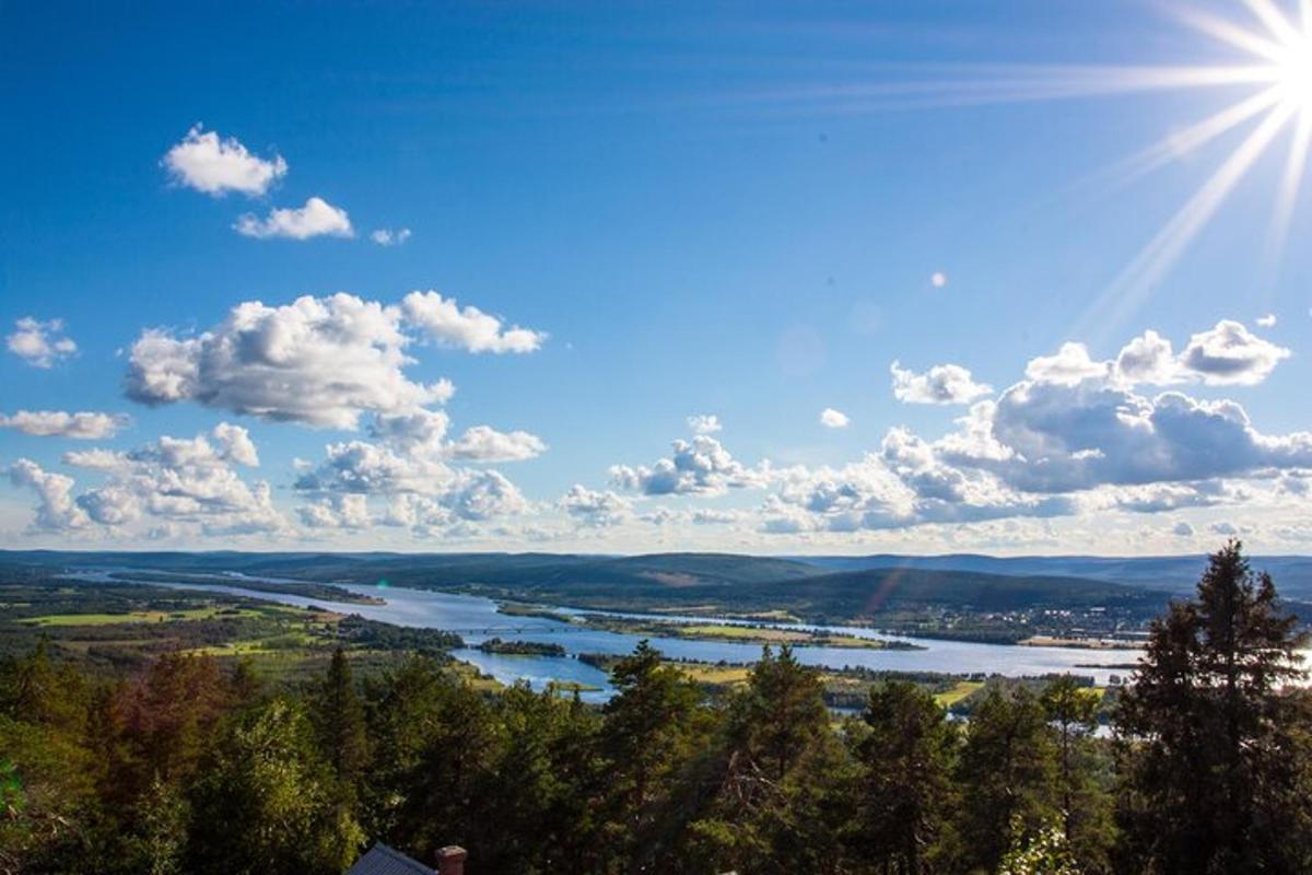 a view of a river with the sun in the sky