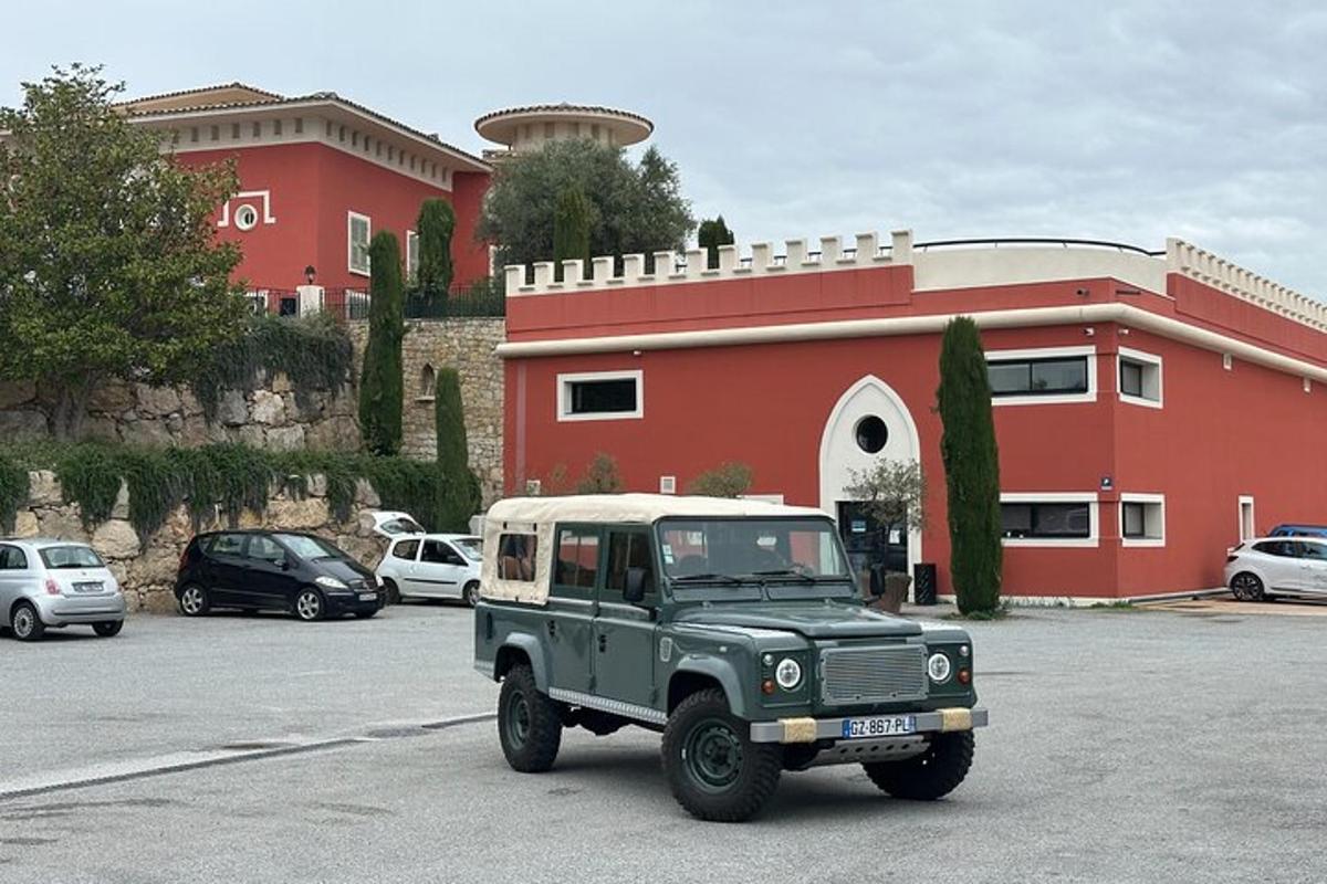 un jeep verd aparcat en un aparcament davant d'un edifici