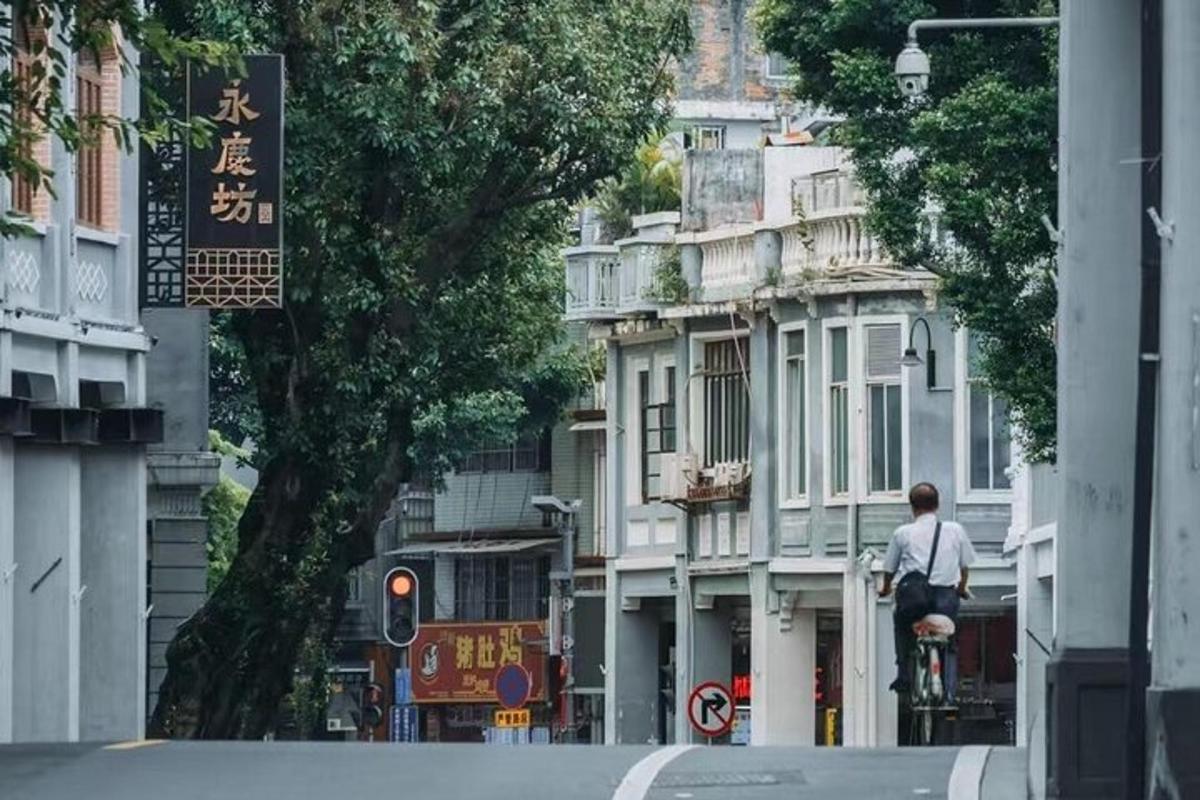 a man riding a bike down a city street
