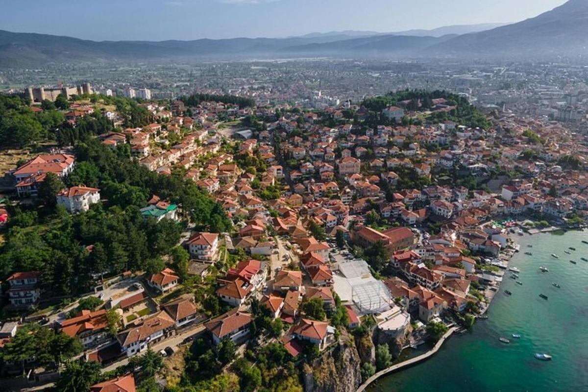 an aerial view of a town next to the water