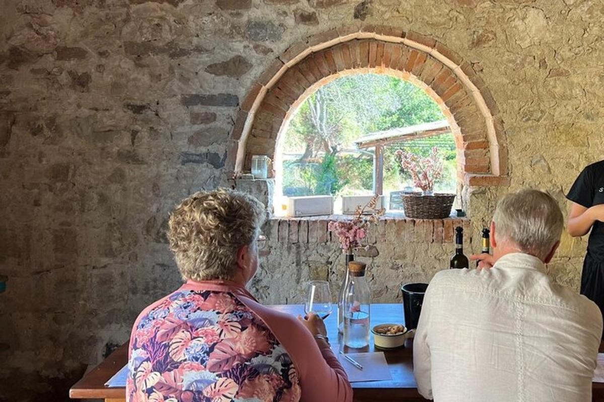 two people sitting at a table with a window