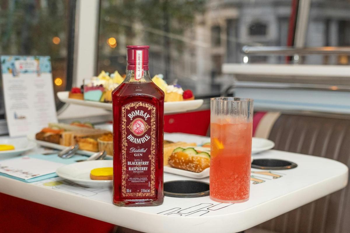 a bottle of alcohol sitting on a table with a drink