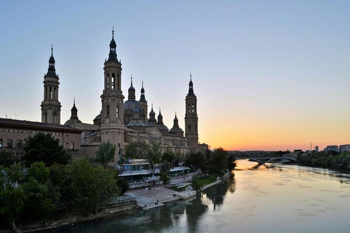 a large building with towers and a river