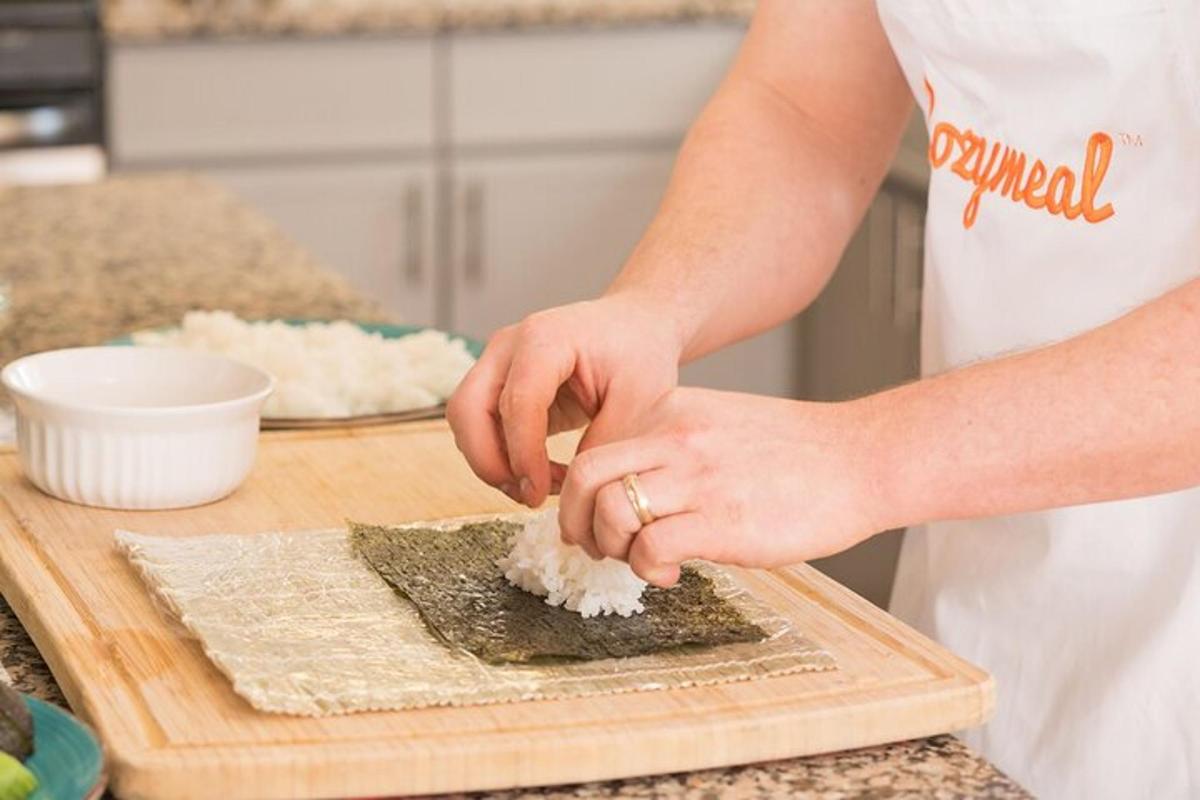 a woman in a kitchen preparing food on a cutting board