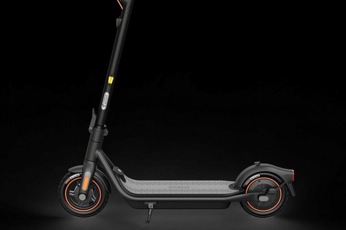 a black scooter with red wheels on a black background
