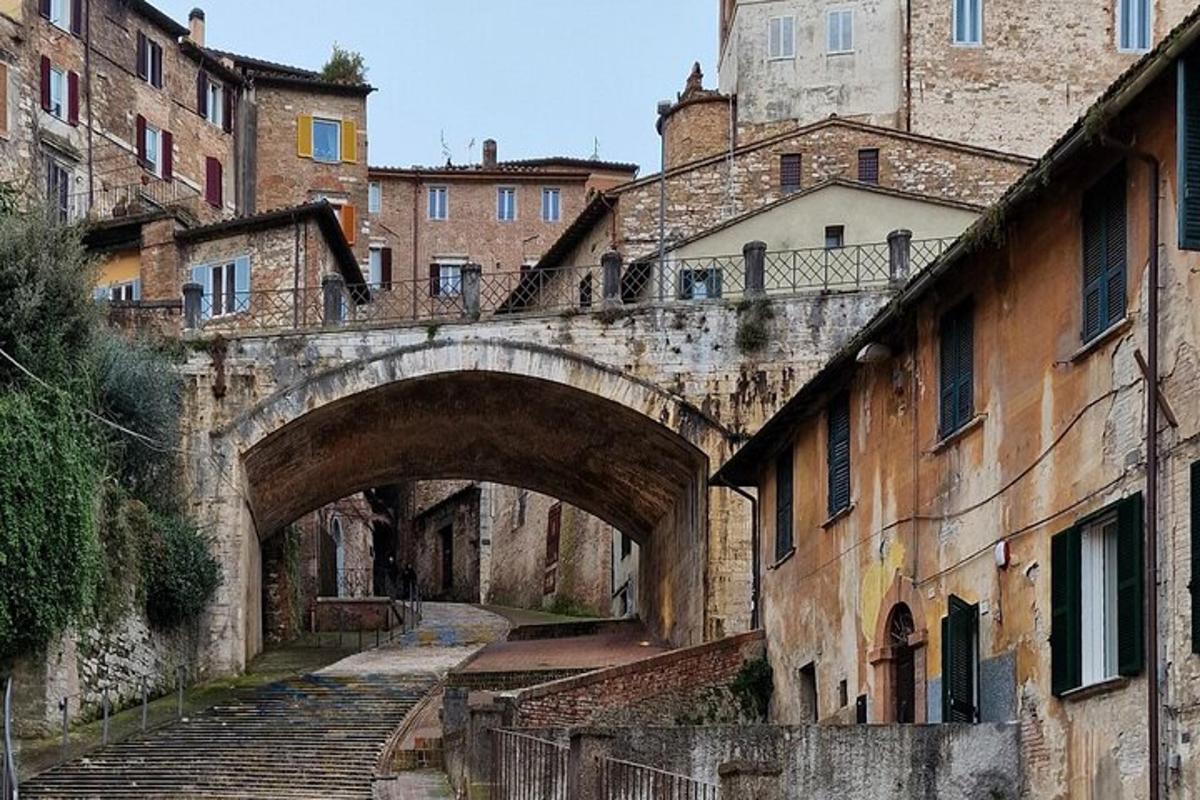 an old stone bridge over an alley with stairs