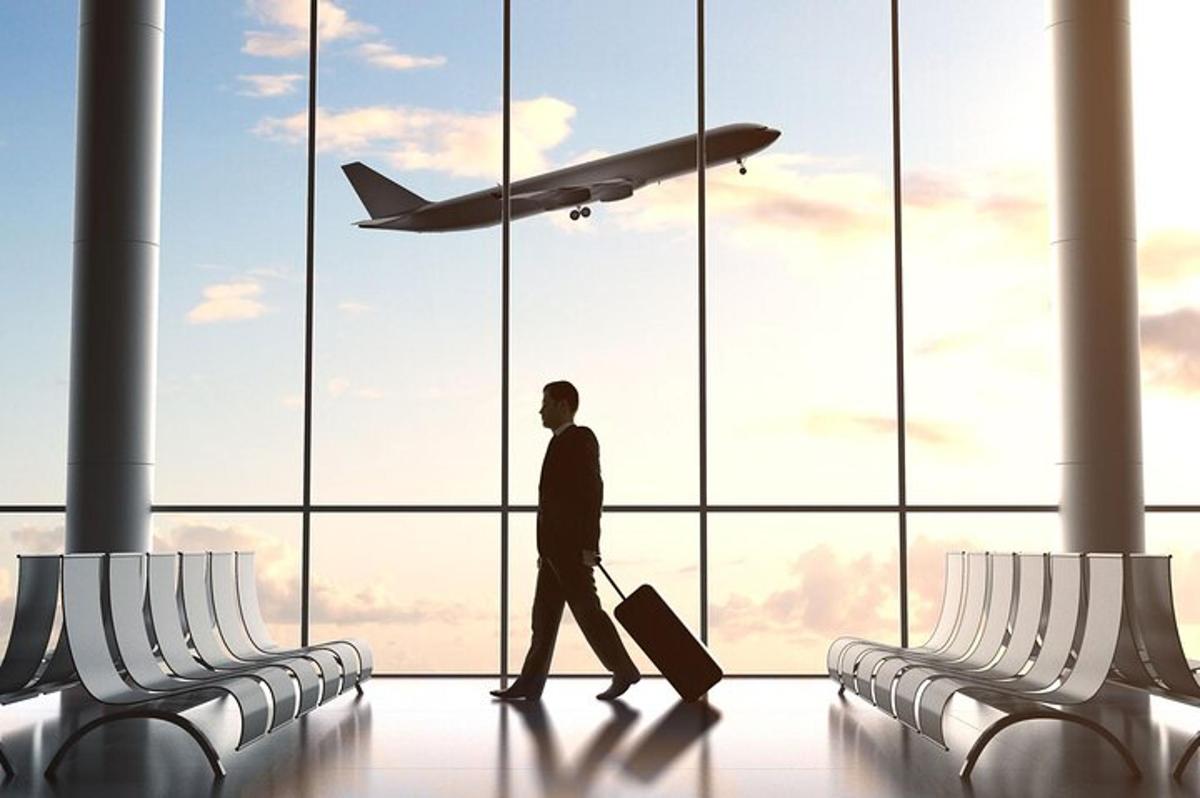 a man walking through an airport looking at an airplane