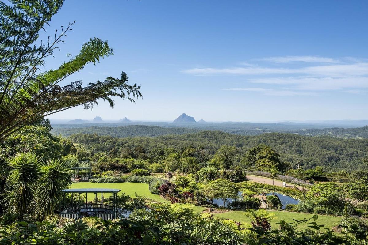 a view of a golf course with mountains in the background