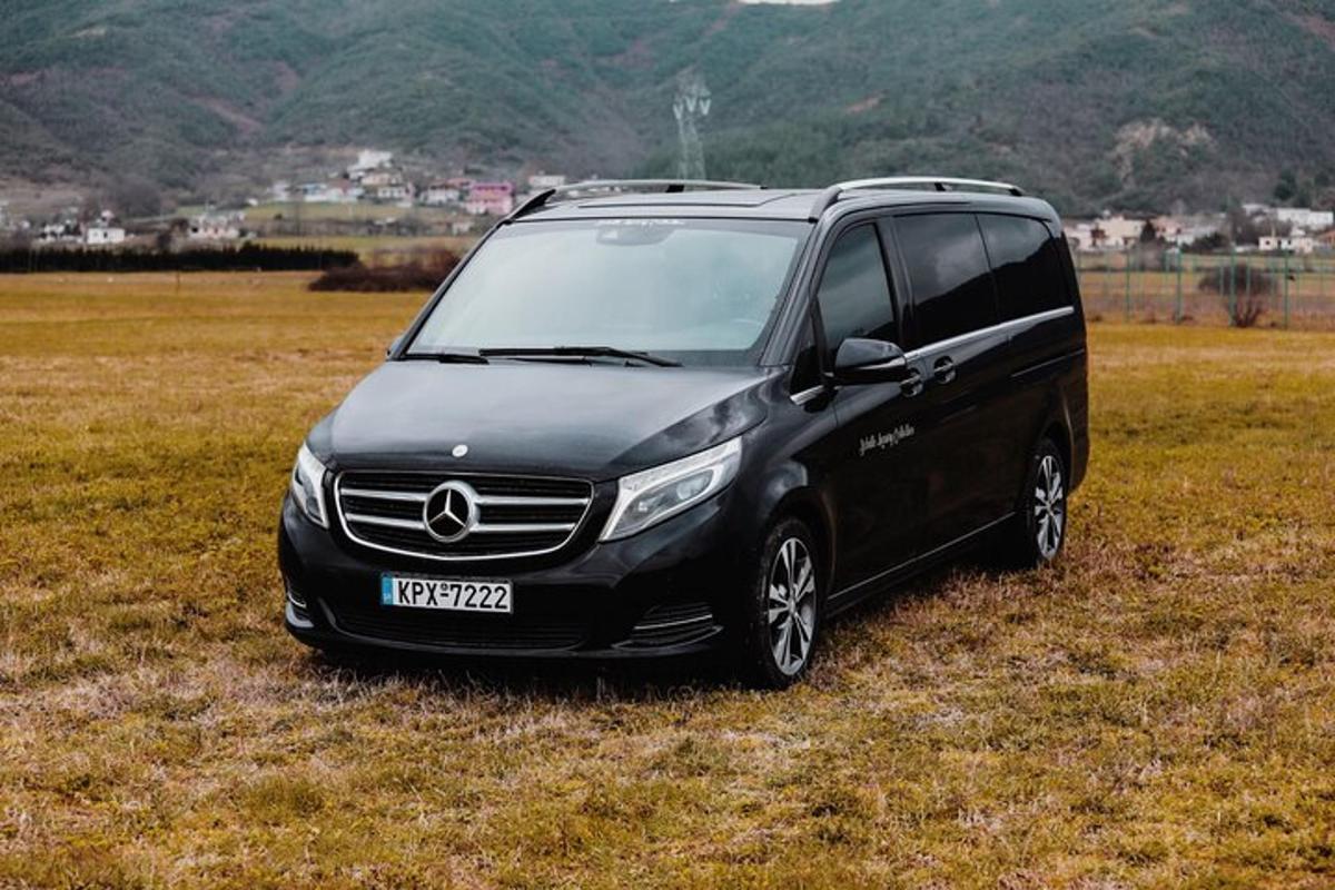 a black van parked in a field of grass