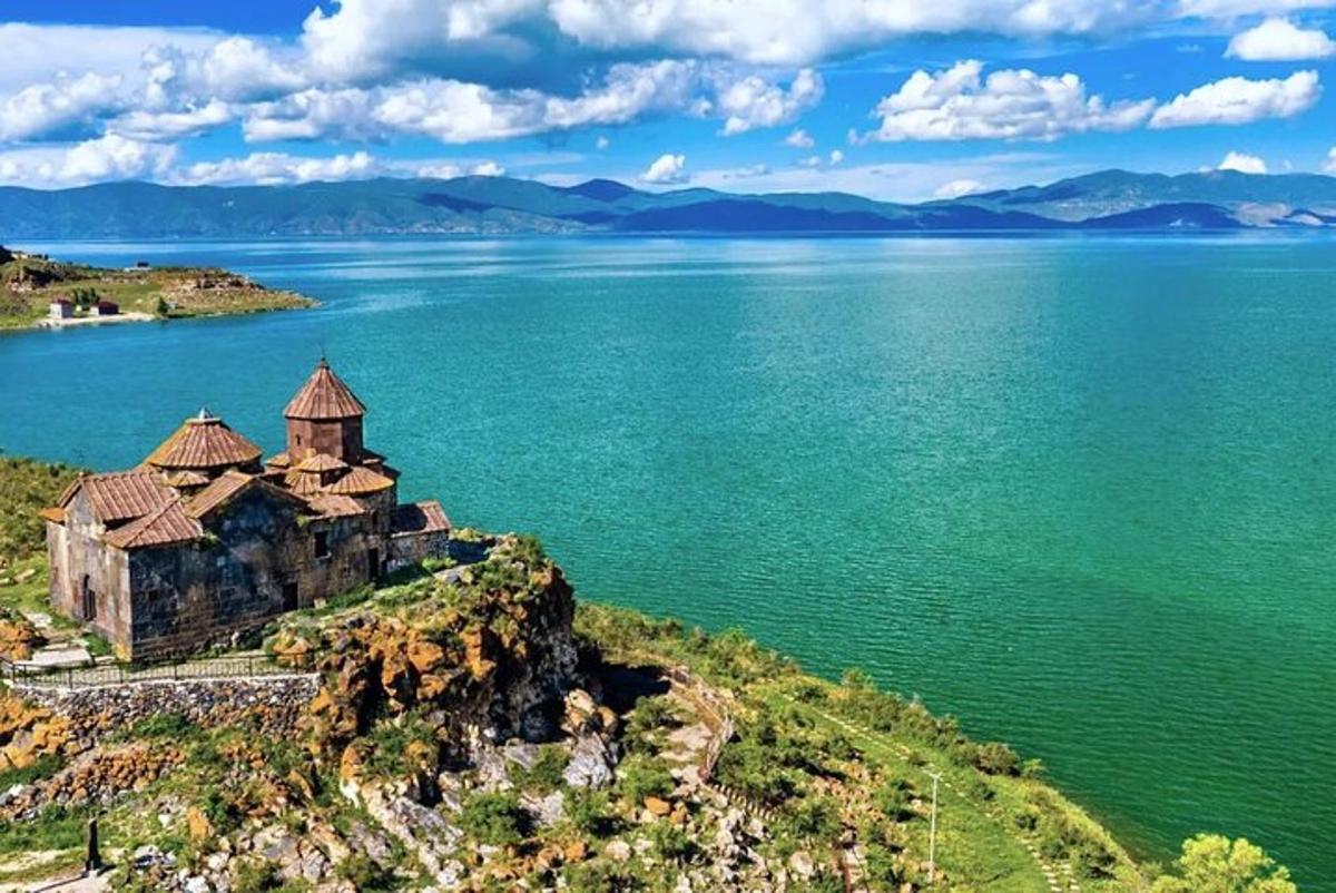 an old building on the shore of a large body of water
