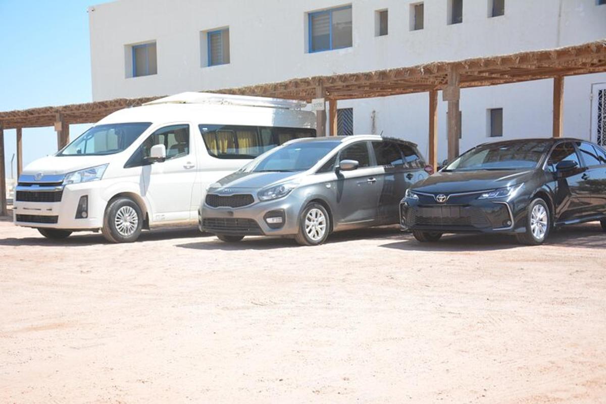 Tres coches estacionados en un estacionamiento al lado de un edificio