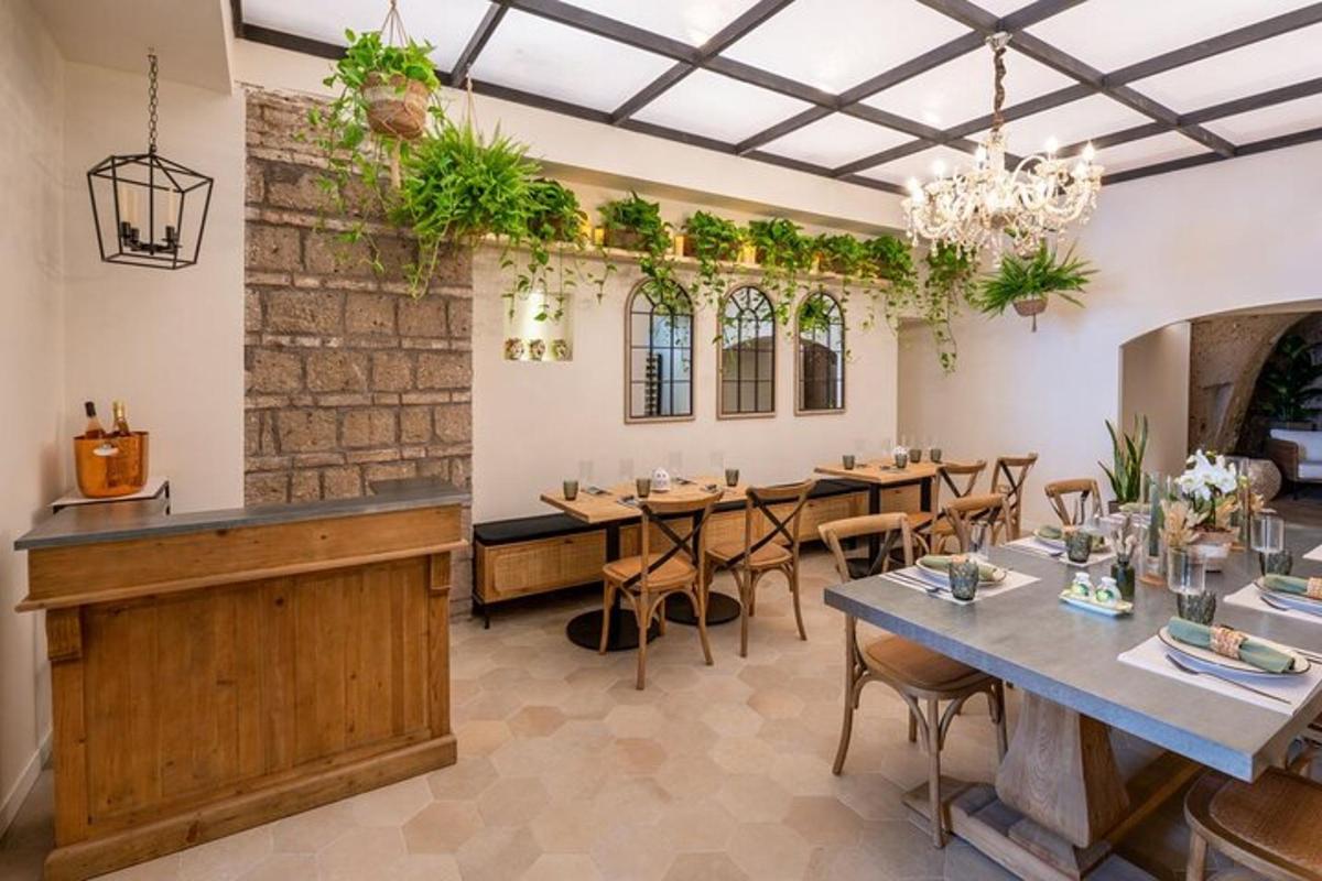 a restaurant with tables and chairs and plants