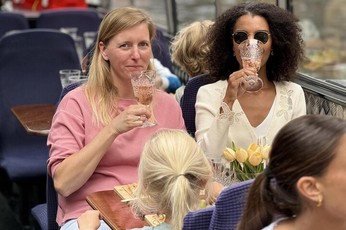 two women and a child are holding wine glasses