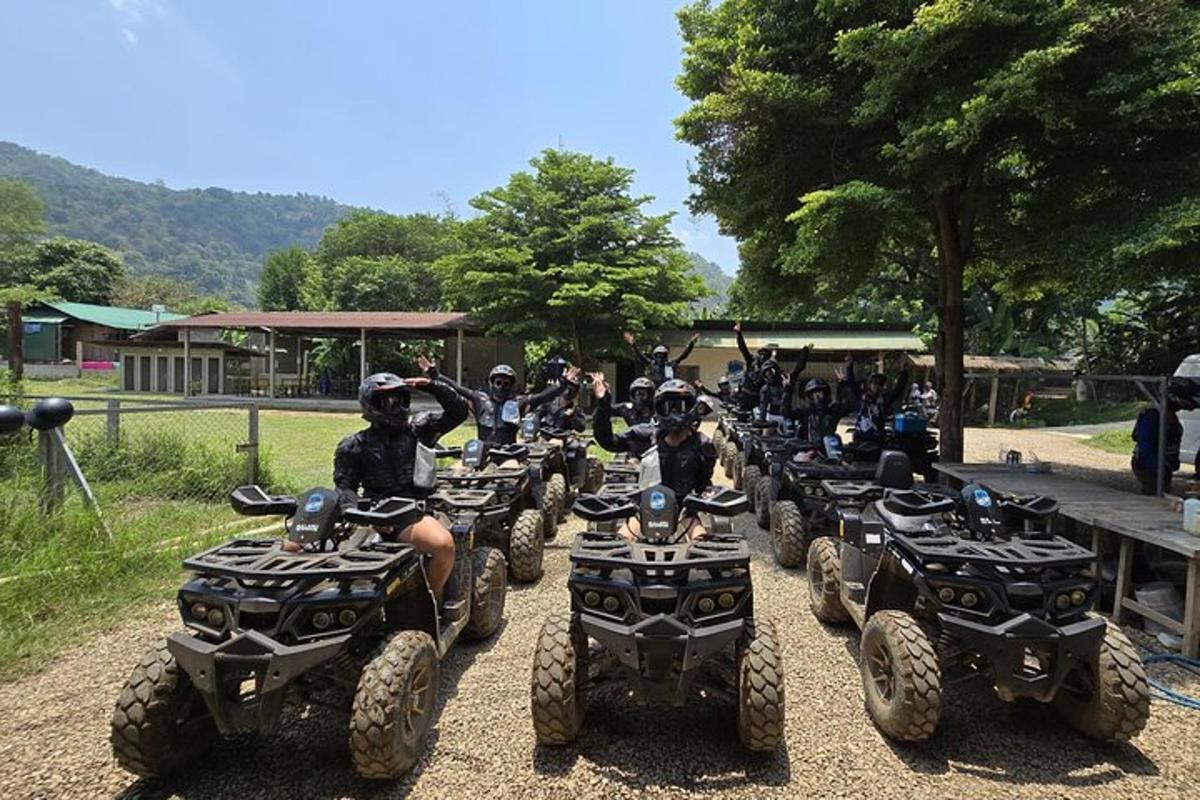 a group of people riding atvs down a dirt road