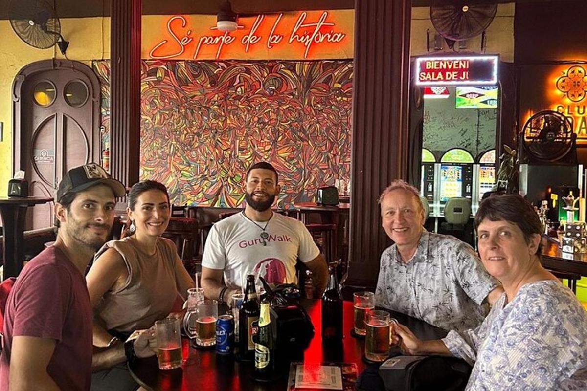 a group of people sitting at a table in a bar