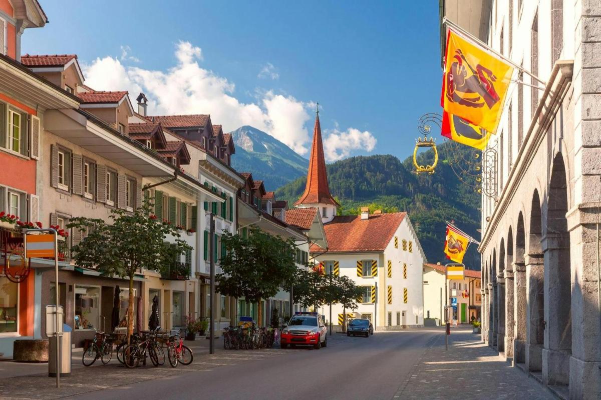a street in a town with a mountain in the background
