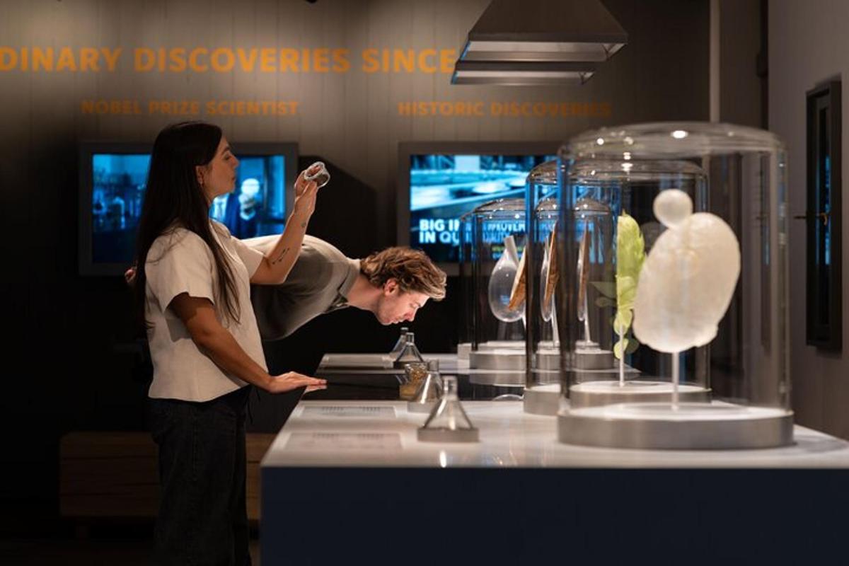 a man and a woman looking at a display of vases