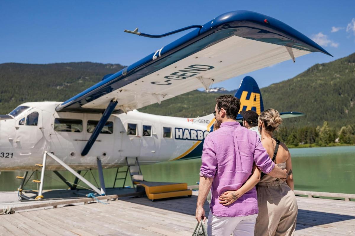 a man and a woman standing next to a plane