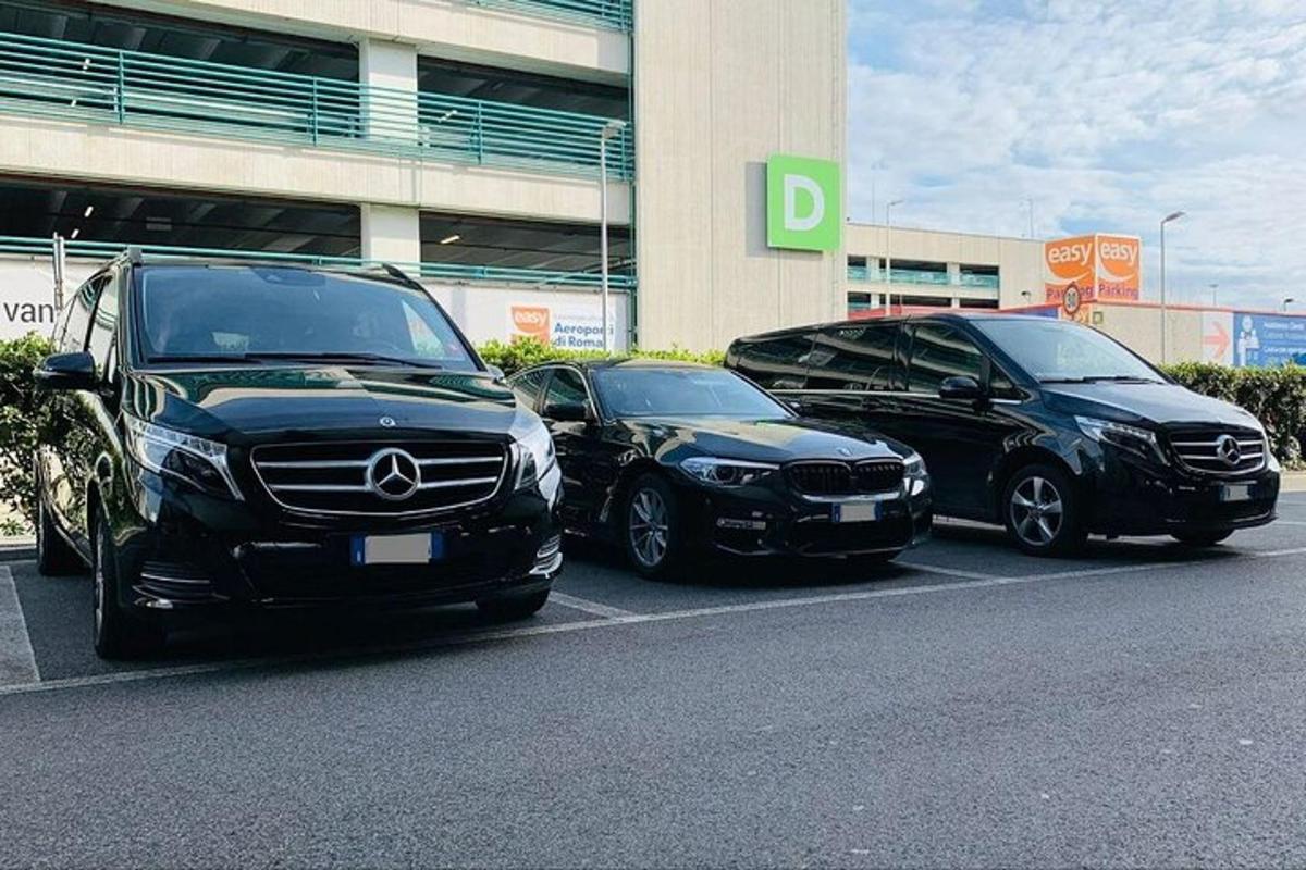 three cars parked in a parking lot in front of a building