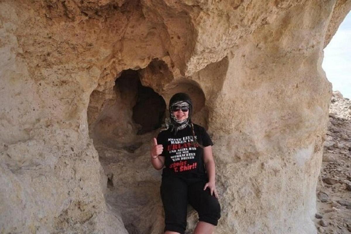 a man standing in front of a cave